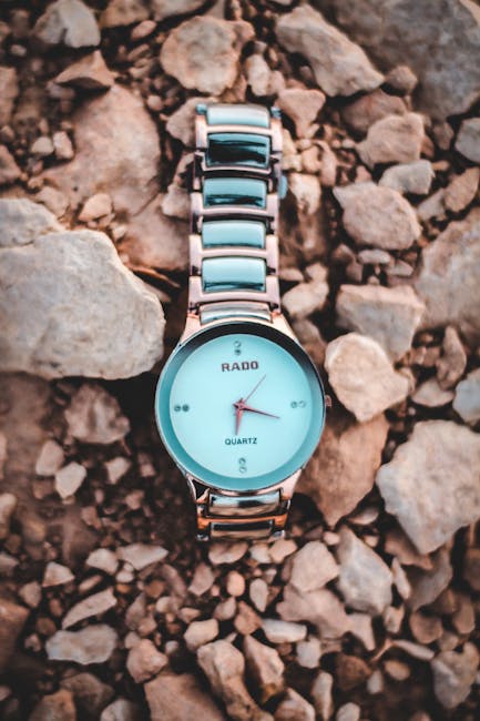 Stylish Rado watch displayed on rugged rocks for a modern minimalism touch.